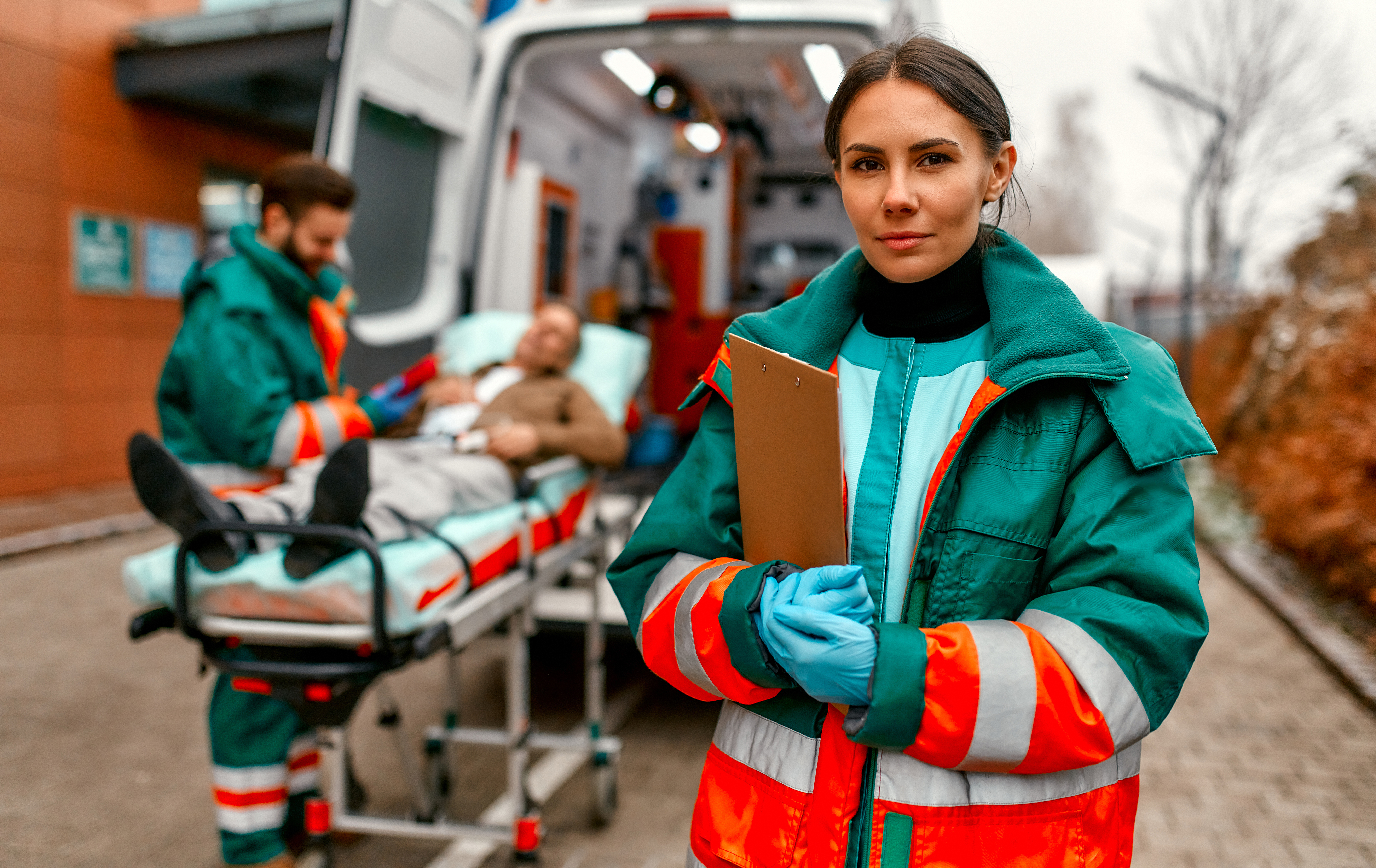 paramedic stands in front of ambulance patient in 2026 01 09 07 08 26 utc